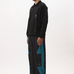 The AKTIV-8 TRACKPANT - BLACK TEAL available online with global shipping, and in PAM Stores Melbourne and Sydney.