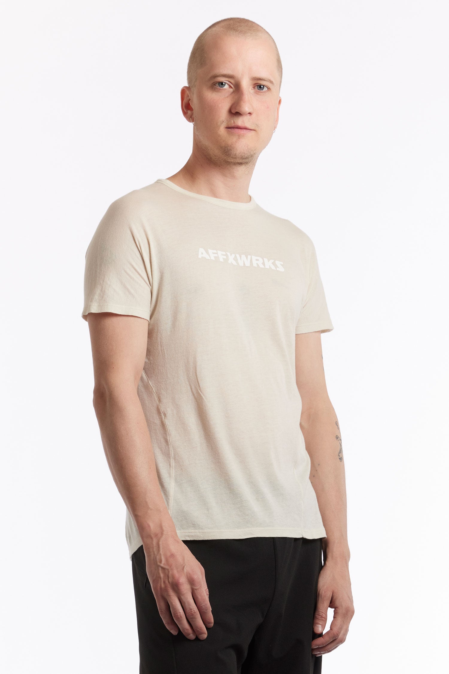 The AFFXWRKS - SHOULDERLESS TEE DUST WHITE available online with global shipping, and in PAM Stores Melbourne and Sydney.