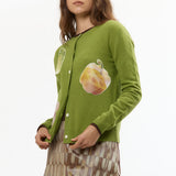 The VEGGIE PATCHWORK GREEN CARDIGAN available online with global shipping, and in PAM Stores Melbourne and Sydney.