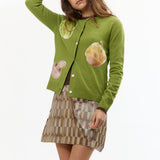 The VEGGIE PATCHWORK GREEN CARDIGAN available online with global shipping, and in PAM Stores Melbourne and Sydney.