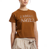 The J'ADORO ARIES DIAMANTE SS BABY TEE BROWN  available online with global shipping, and in PAM Stores Melbourne and Sydney.