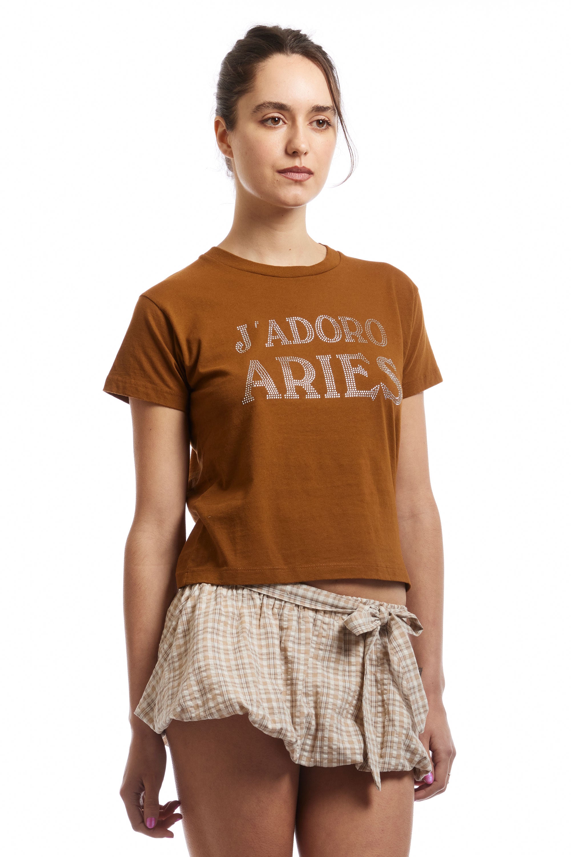 The J'ADORO ARIES DIAMANTE SS BABY TEE BROWN  available online with global shipping, and in PAM Stores Melbourne and Sydney.