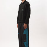 The AKTIV-8 TRACKPANT - BLACK TEAL available online with global shipping, and in PAM Stores Melbourne and Sydney.