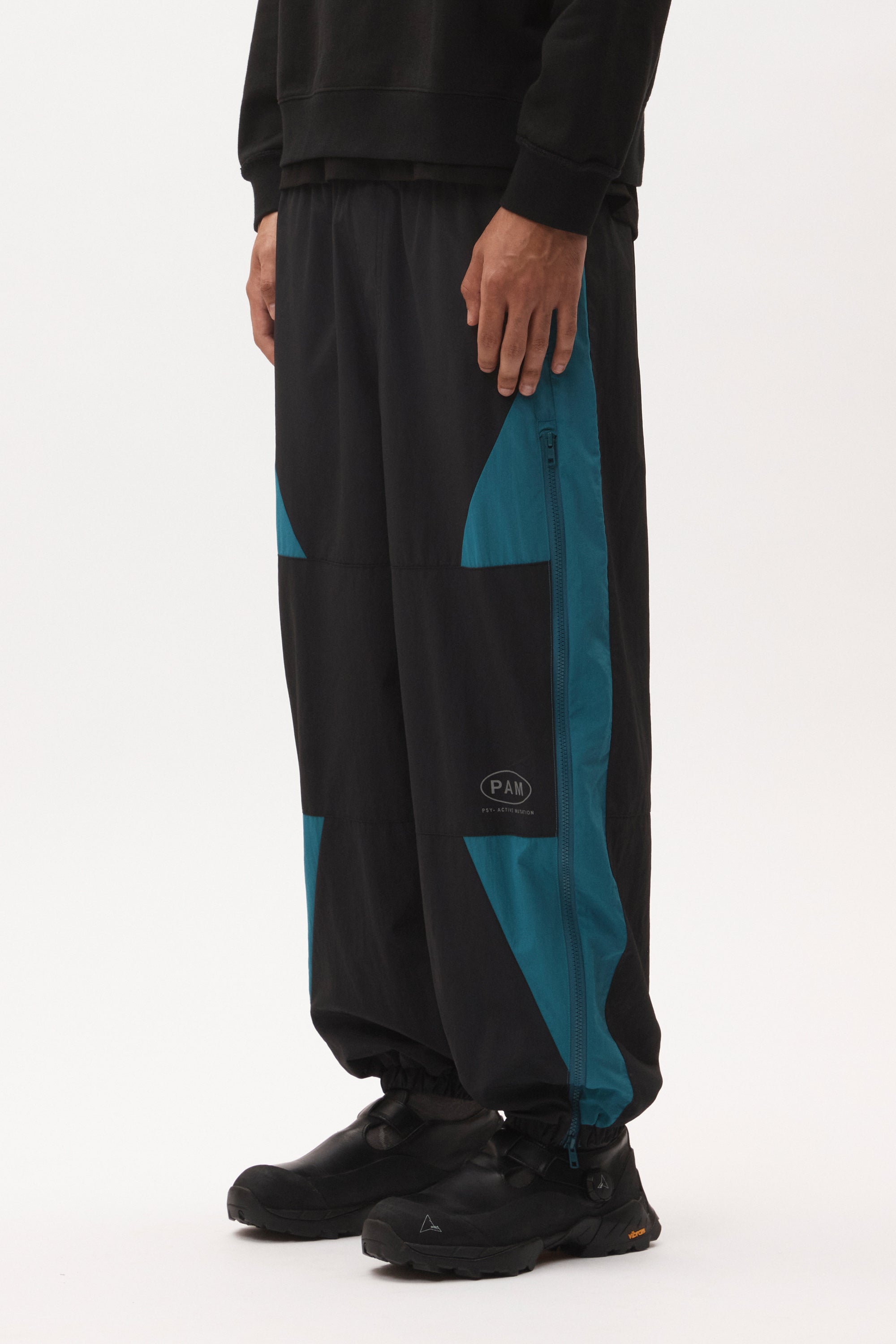 The AKTIV-8 TRACKPANT - BLACK TEAL available online with global shipping, and in PAM Stores Melbourne and Sydney.
