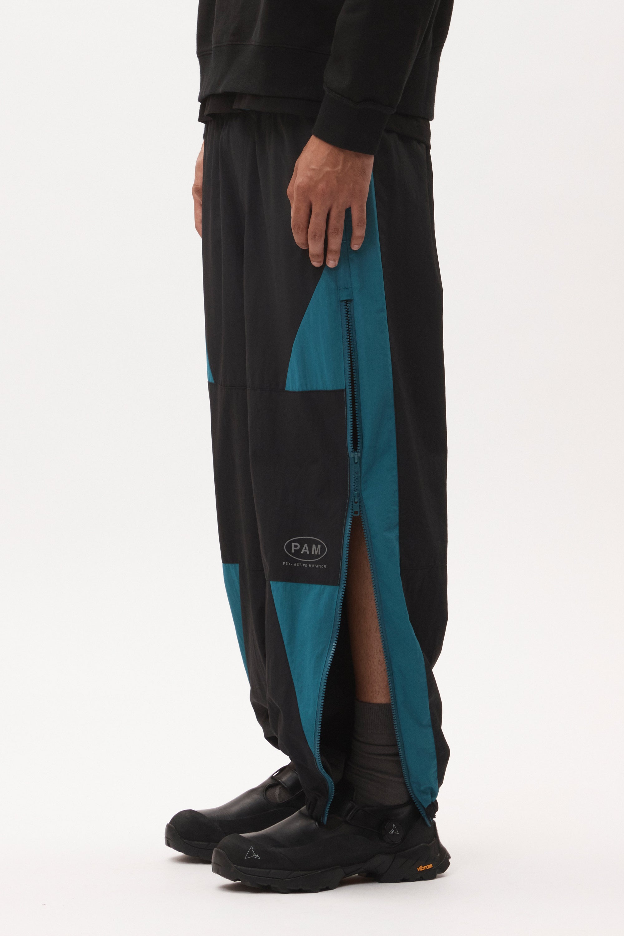 The AKTIV-8 TRACKPANT - BLACK TEAL available online with global shipping, and in PAM Stores Melbourne and Sydney.