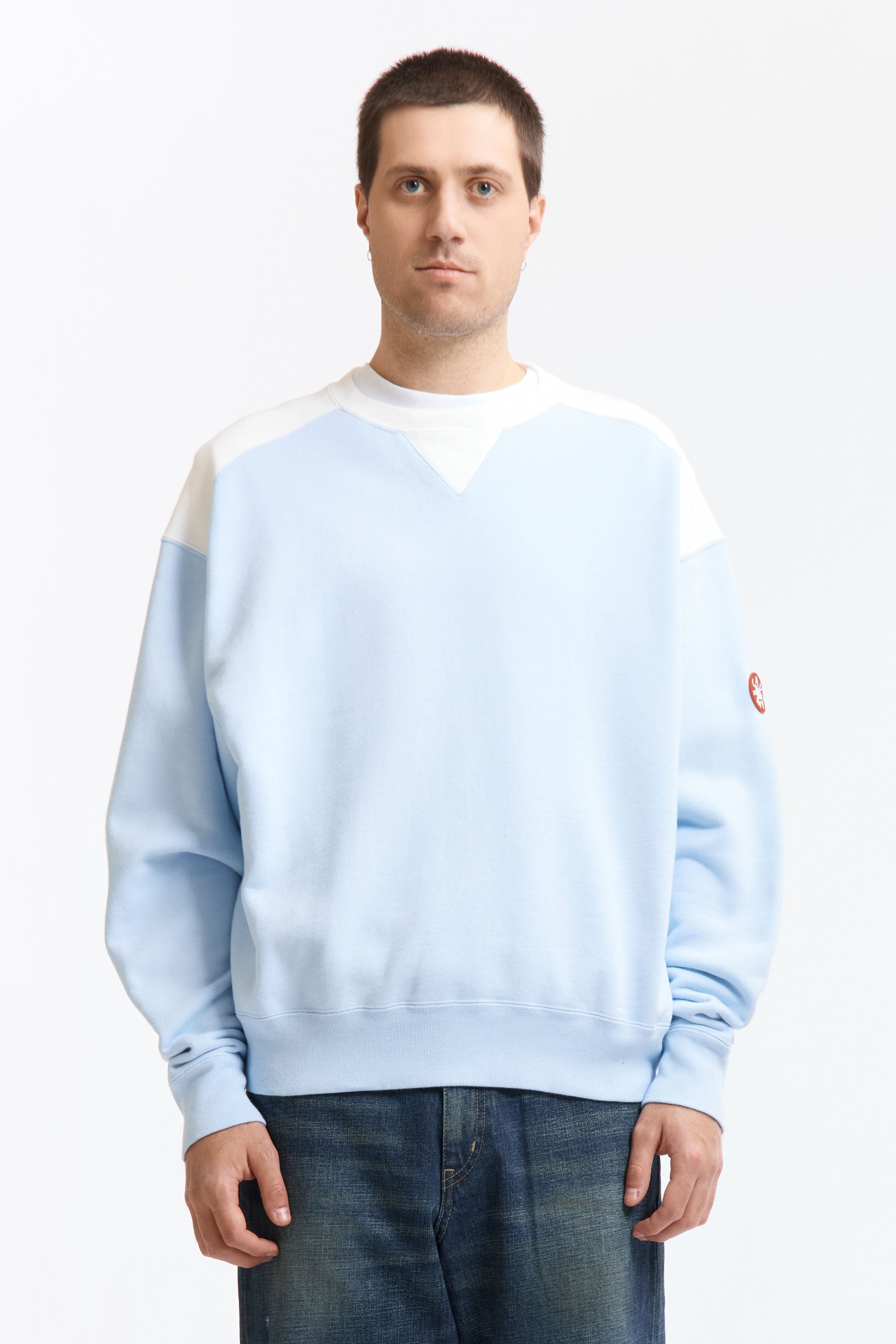 The PANEL SHOULDER CREW NECK BLUE available online with global shipping, and in PAM Stores Melbourne and Sydney.