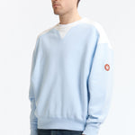 The PANEL SHOULDER CREW NECK BLUE available online with global shipping, and in PAM Stores Melbourne and Sydney.