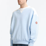 The PANEL SHOULDER CREW NECK BLUE available online with global shipping, and in PAM Stores Melbourne and Sydney.