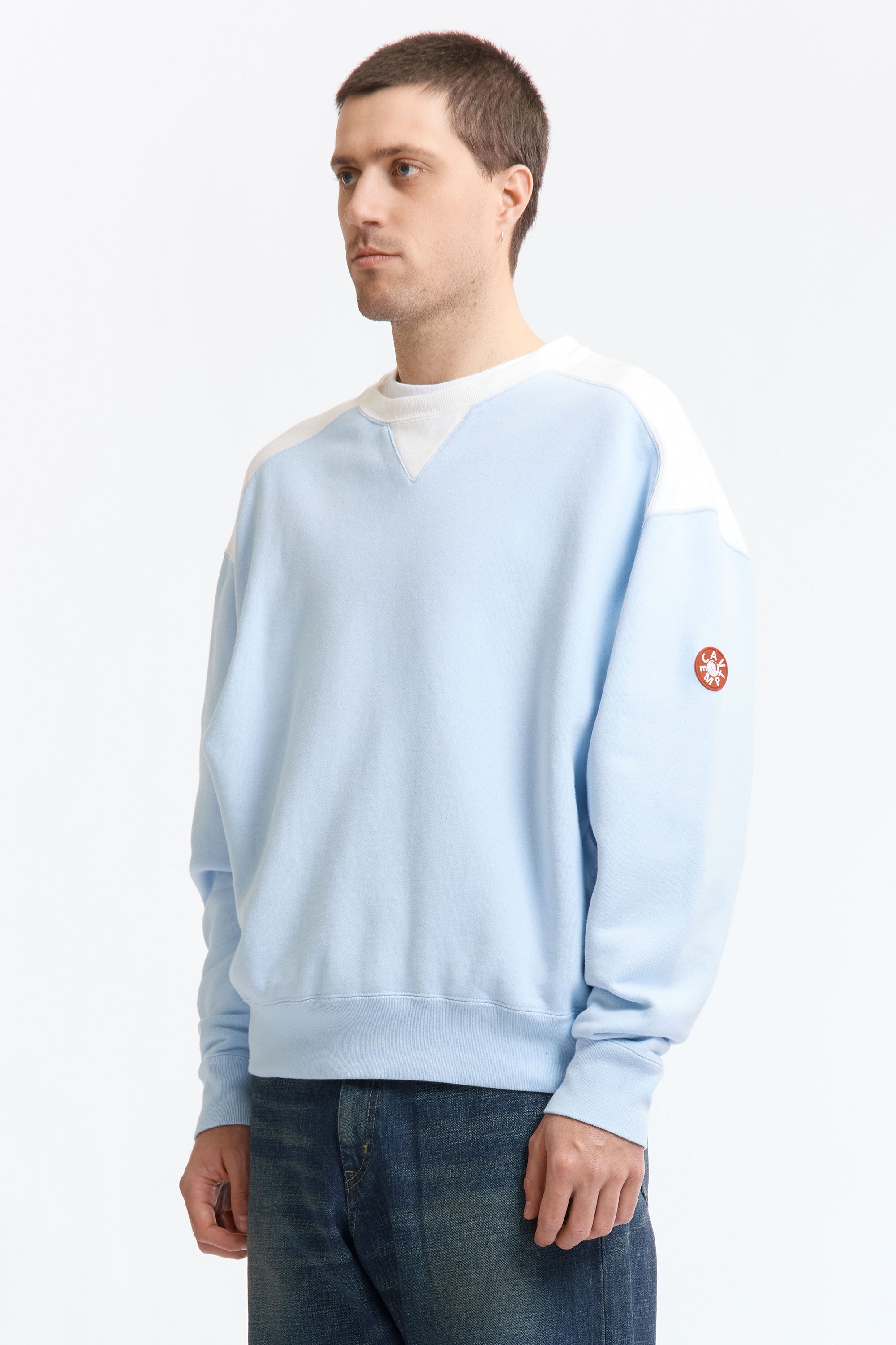 The PANEL SHOULDER CREW NECK BLUE available online with global shipping, and in PAM Stores Melbourne and Sydney.