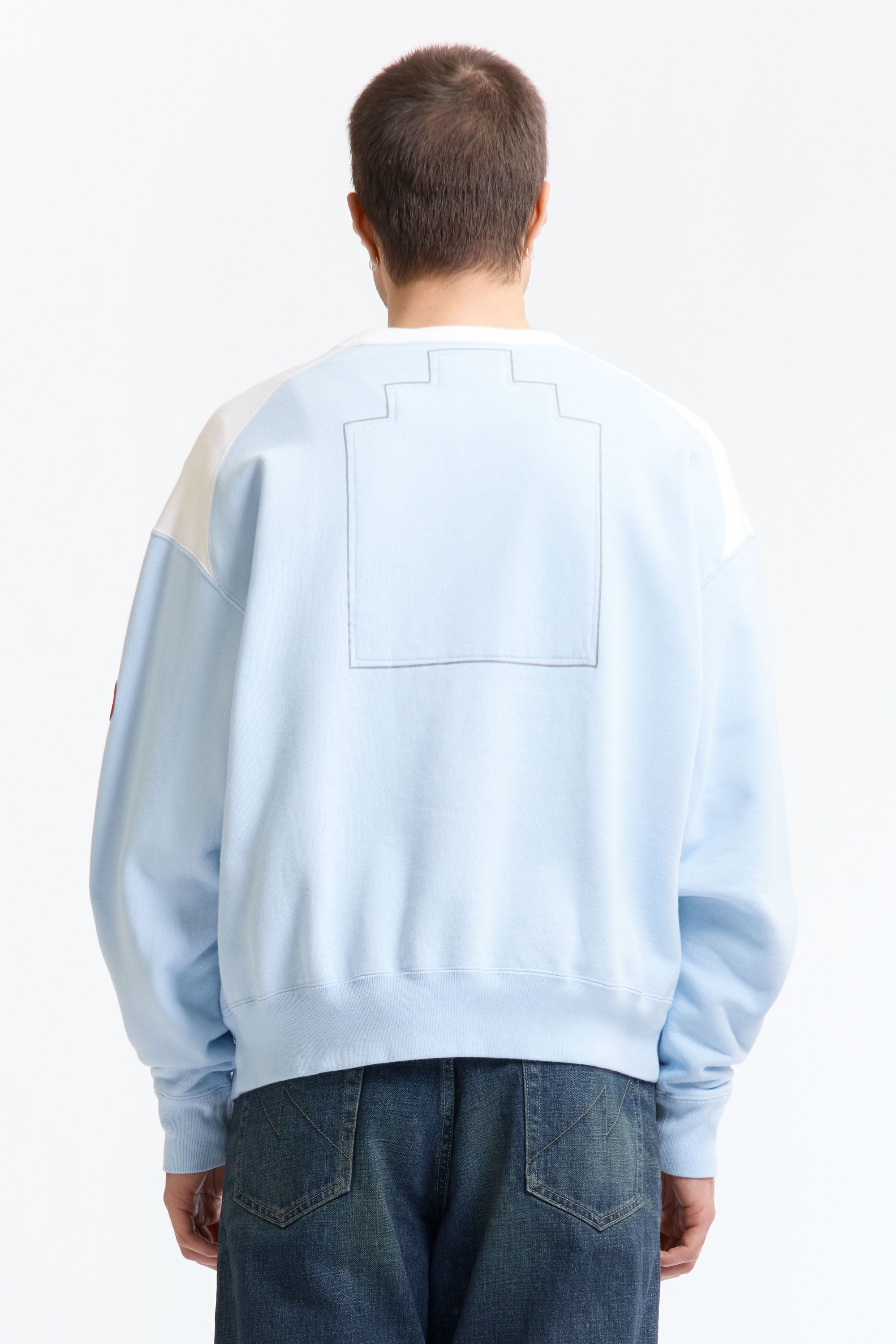 The PANEL SHOULDER CREW NECK BLUE available online with global shipping, and in PAM Stores Melbourne and Sydney.