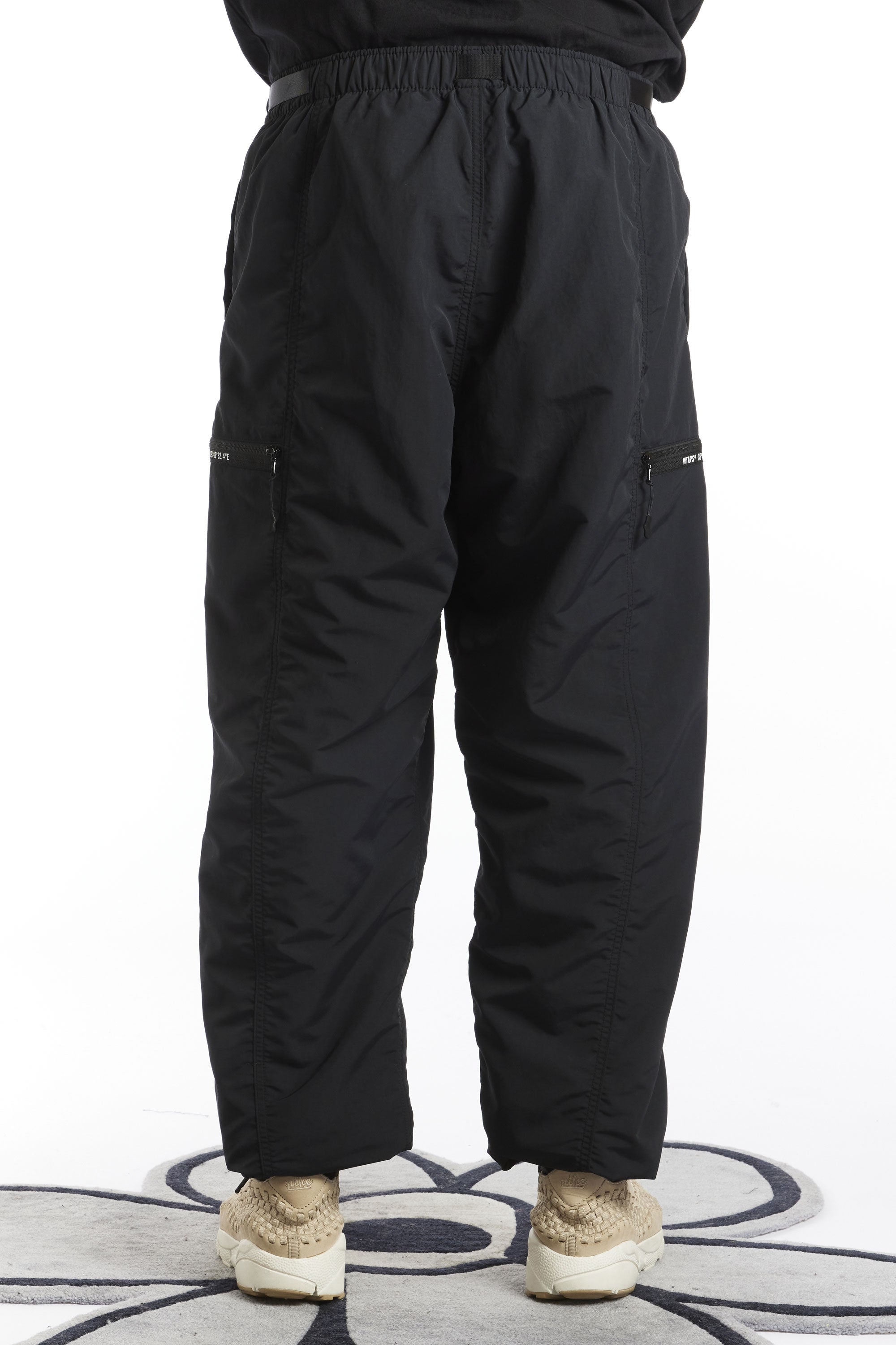 The WTAPS - SPST2003 NYLON WEATHER TRACKS  TROUSERS  available online with global shipping, and in PAM Stores Melbourne and Sydney.