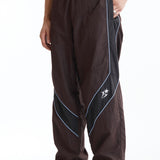 The Panelled Track Pant Brown available online with global shipping, and in PAM Stores Melbourne and Sydney.